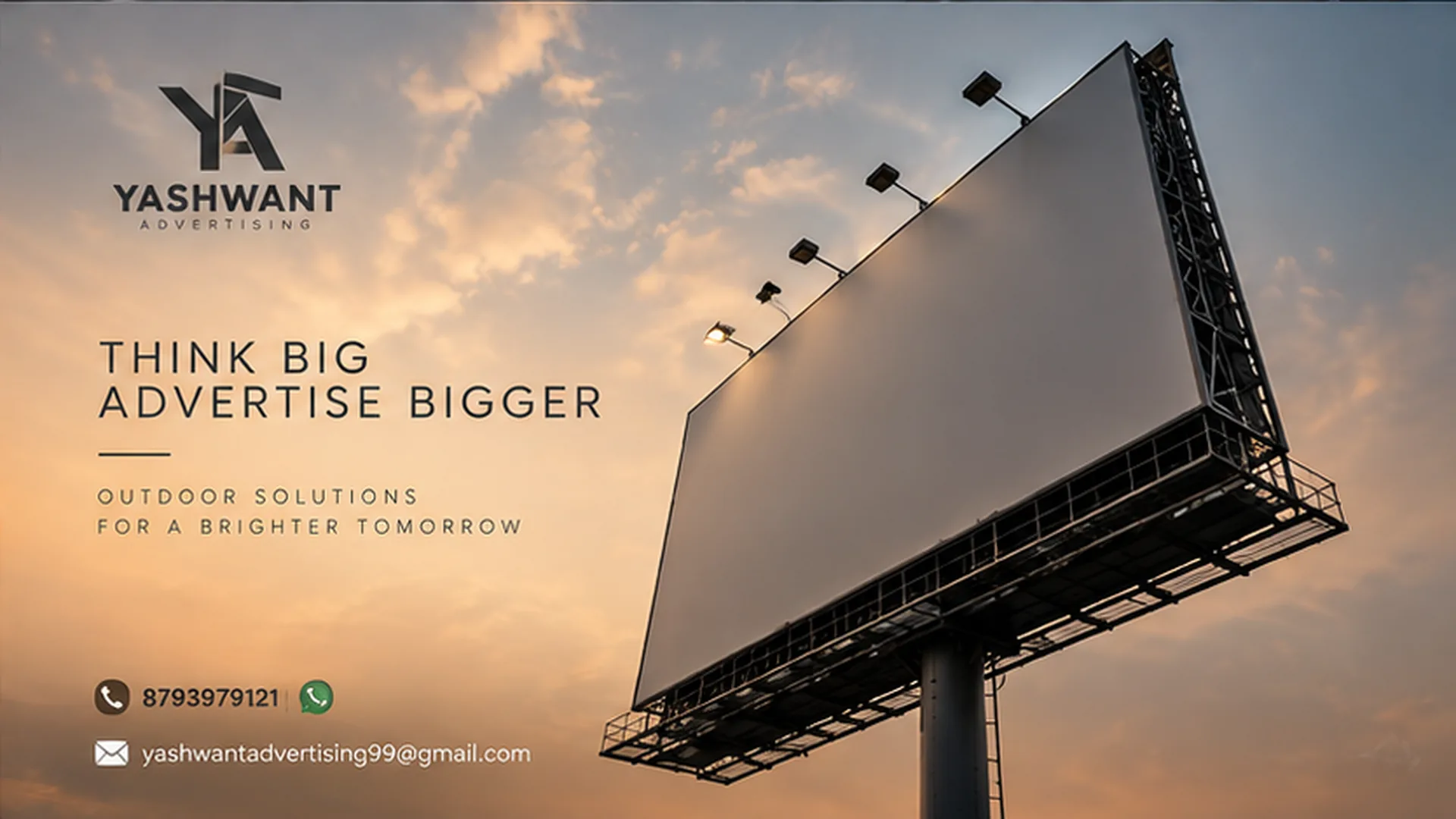 Low-angle view of a Yashwant Advertising billboard structure against a dusk sky
