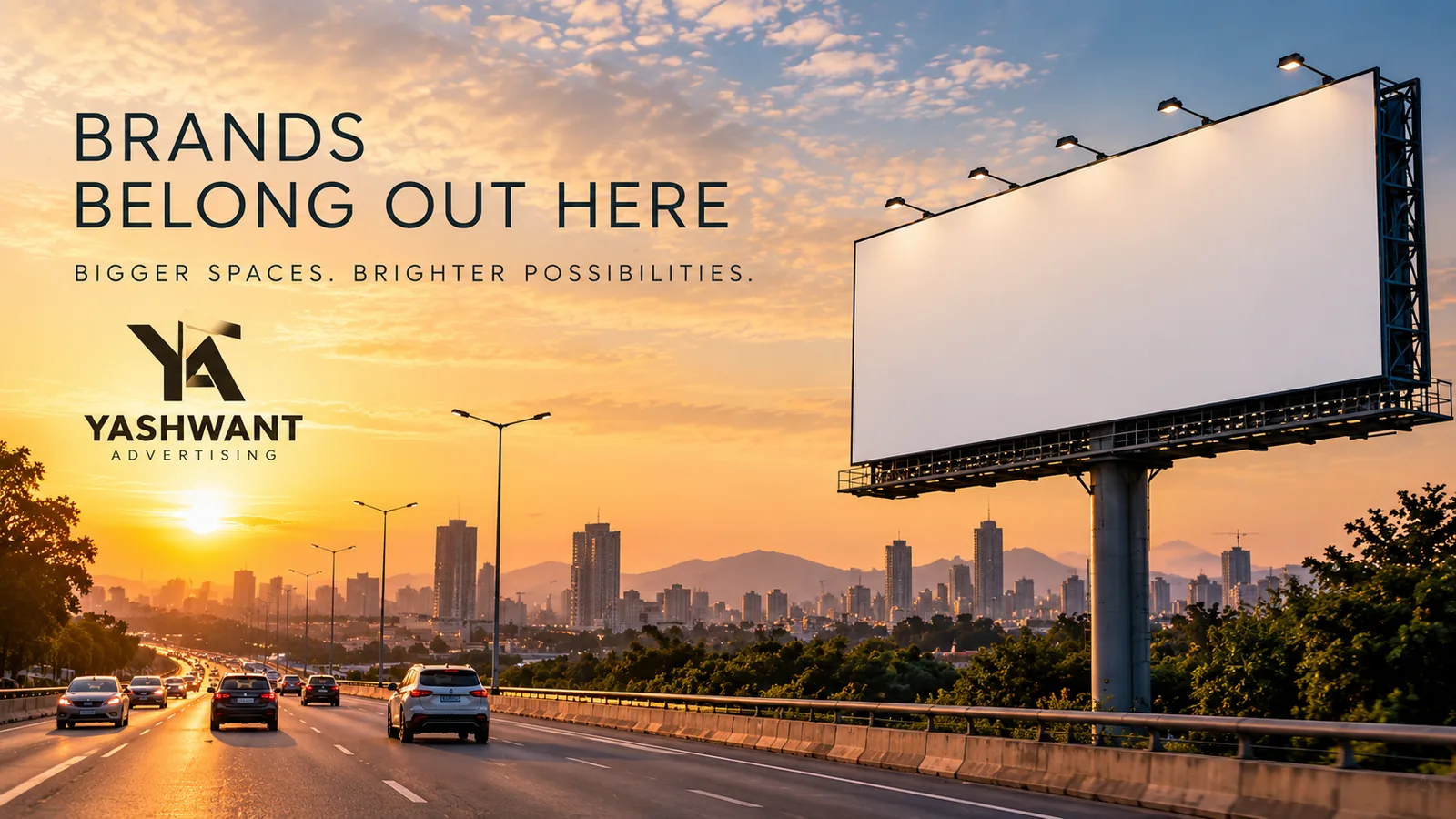 Yashwant Advertising highway billboard at golden hour, with the city skyline behind